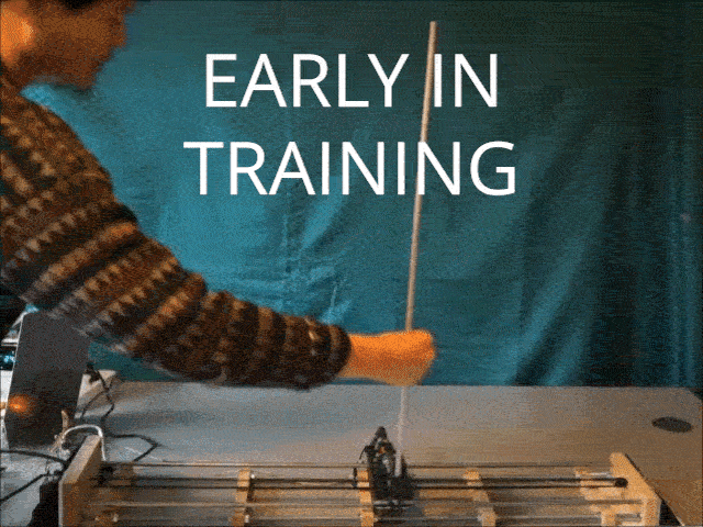 A short video showing a small pole balanced on a cart, moving back and forth across a track. Early in the video, the pole does not balance well. Late in the video the pole remains balanced even when disturbed by someone's hand.