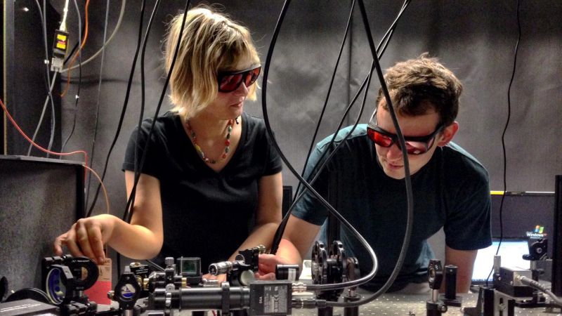 two researchers perform quantum experiments 