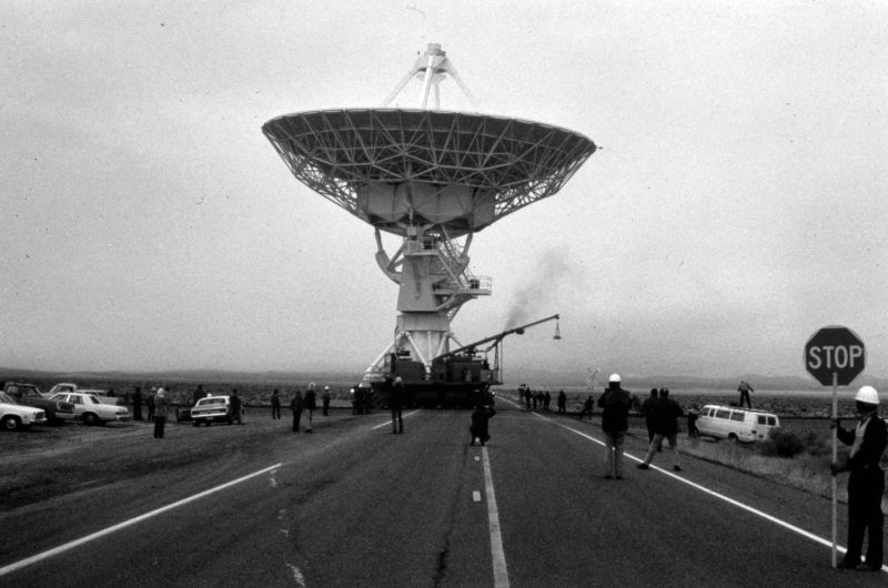 Image of a radio telescope being moved across a street