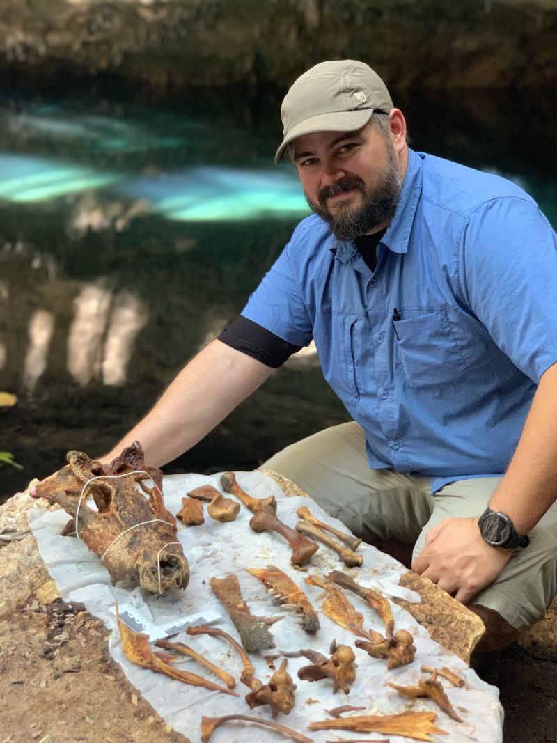 Zack Klukkert poses with crocodile remains