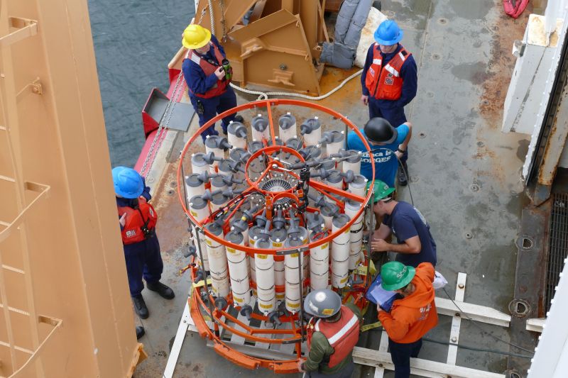 Marine researchers prepare a CTD sensor for launch