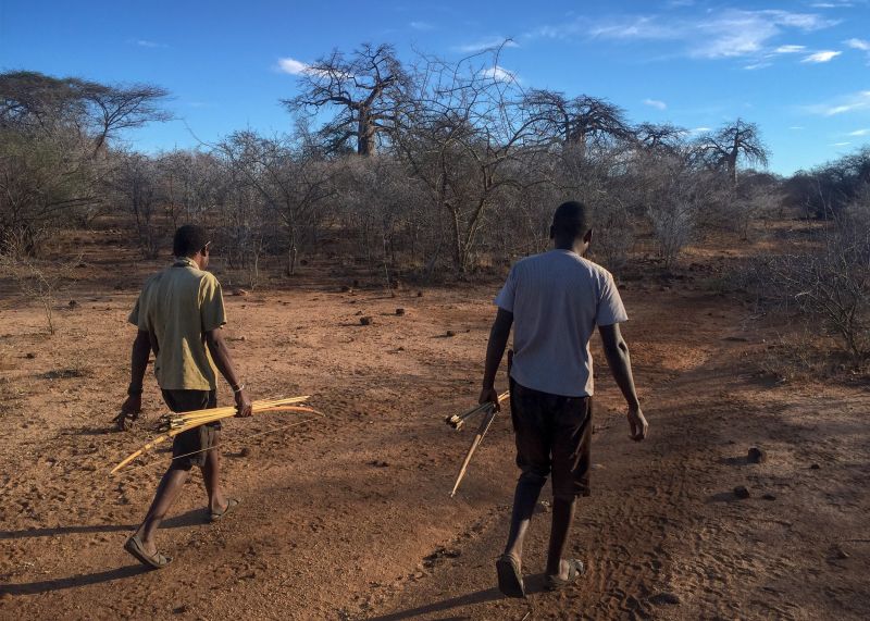 Hadza men follow a game trail