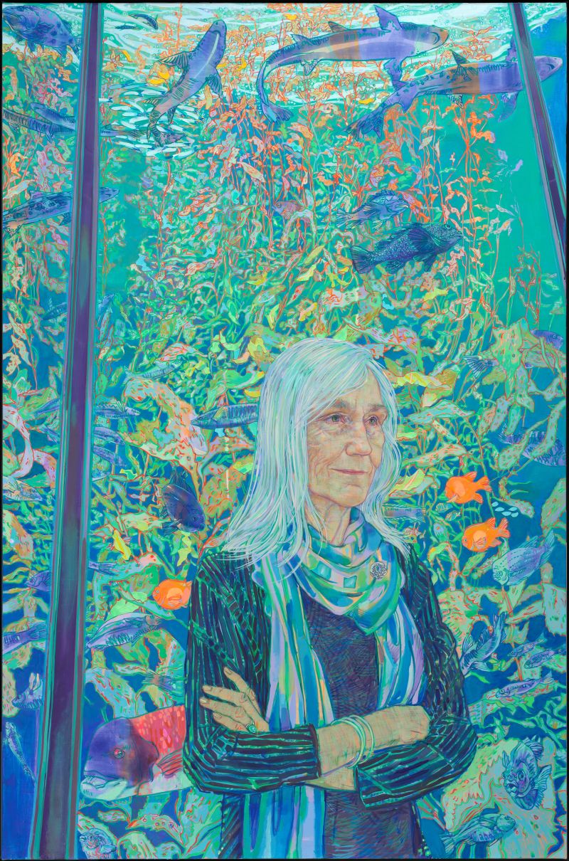 A painting of Julie Packard in front of a large tank of fish and marine life.