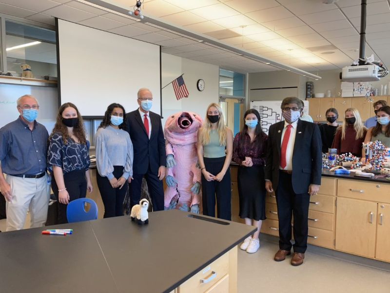 dr  Panchanathan stands with students and professors with a life size person in a tardigrade costume