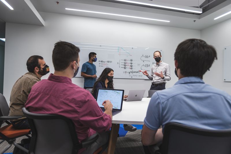 college students in a class staring at a white board