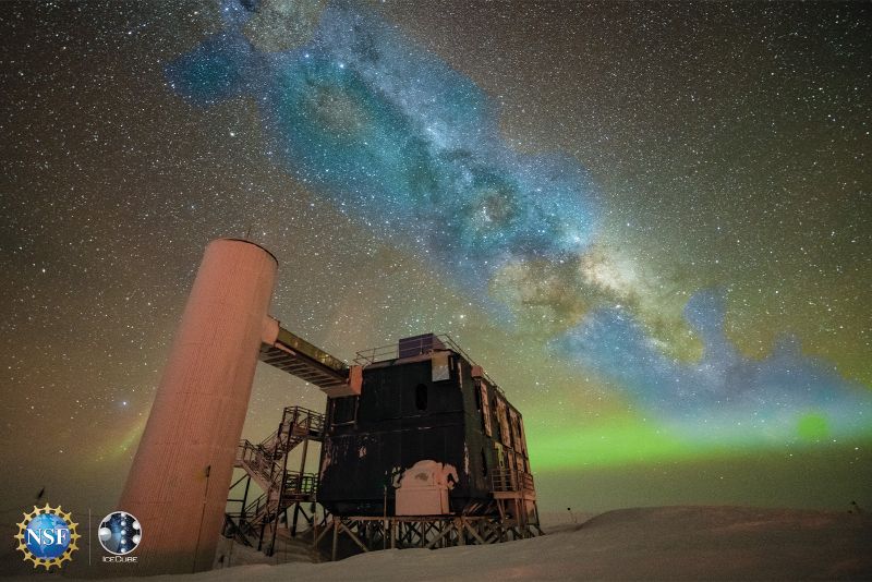An artist's composite image of a photo of the above-ground portion of the IceCube Neutrino Observatory along with the first-ever neutrino-based image of the Milky Way.