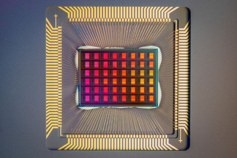A closeup of a computer chip, featuring a red grid surrounded by golden bands