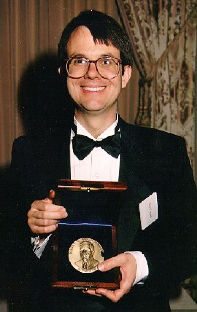 Dr. Eric Cornell holding his medal