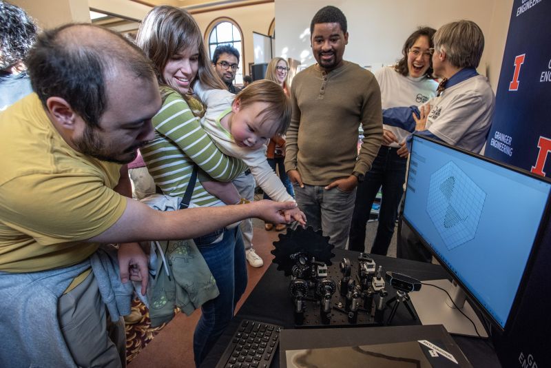 A young attendee of the Public Quantum Network launch event controls the measurement of photons travelling through The Urbana Free Library that are entangled with photons on the University of Illinois Urbana-Champaign campus.