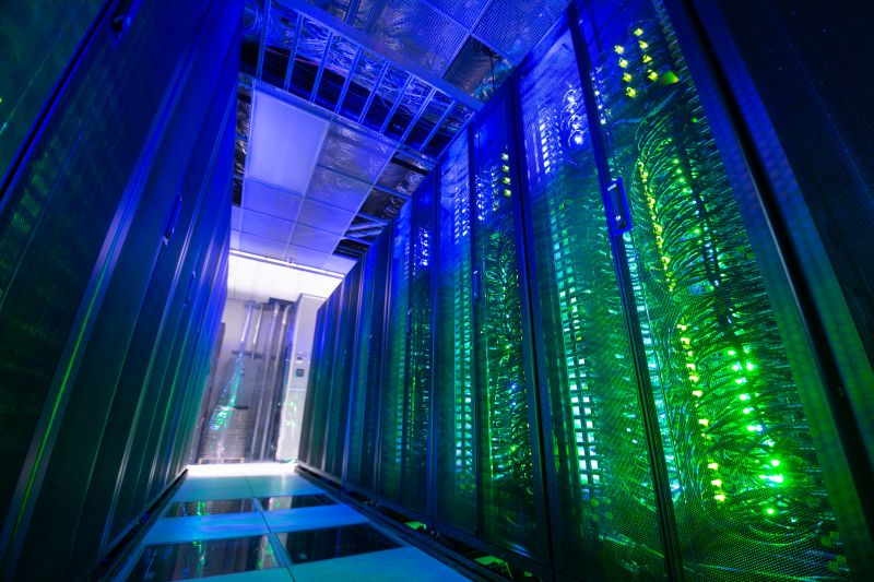 Computer server room with blue and green lights.