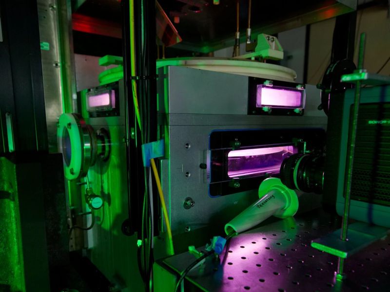 A machine with a glowing purple substance visible through small horizontal windows.