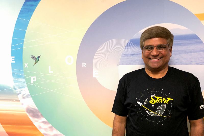 Man standing in front of colorful mural