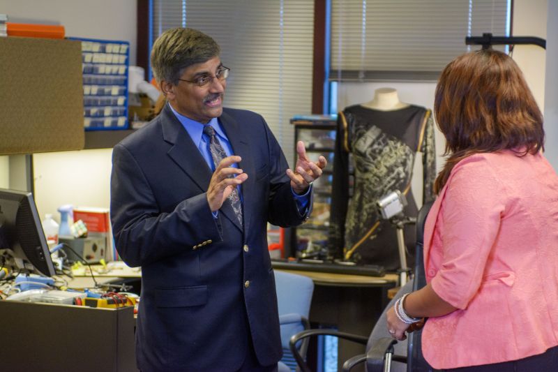 Man discusses a project with a student