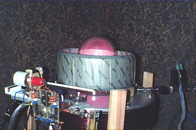 An old looking and complex homemade machine against a wallpaper background