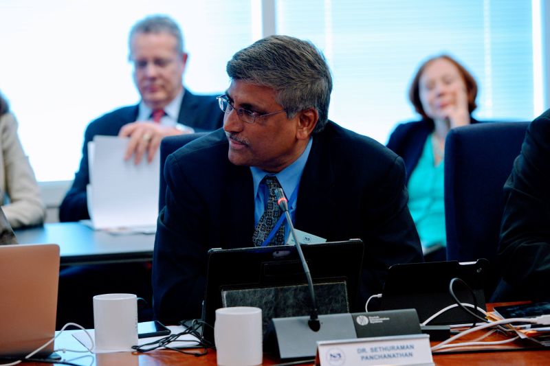A man sits at a conference table during a meeting