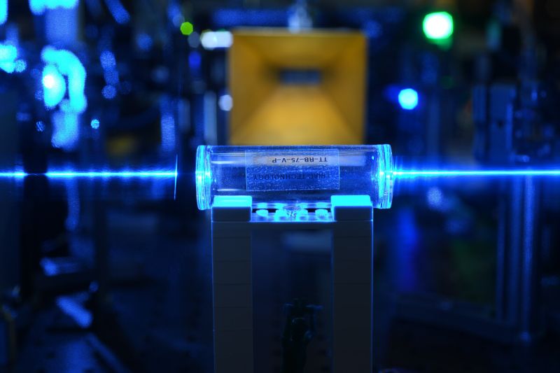 A tube being hit with a beam of light in a laboratory.