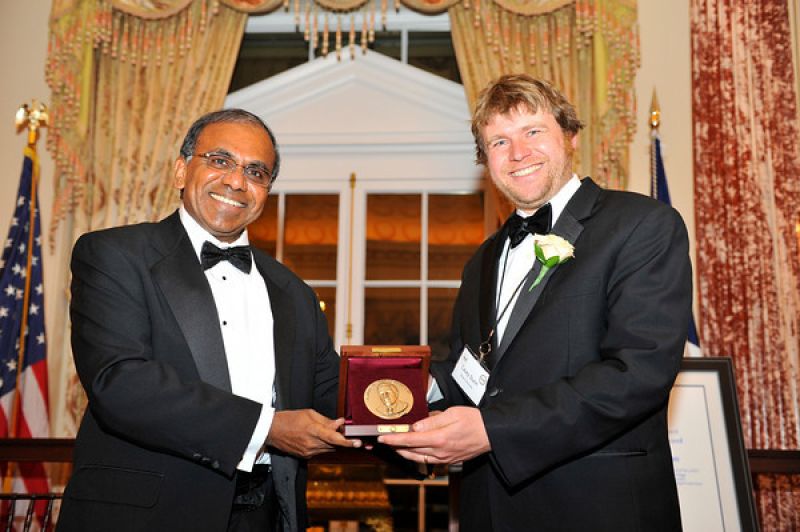 Casey W. Dunn with Subra Suresh, NSF Director holding a medal award