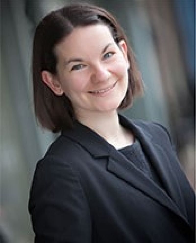 female portrait with short brown hair, wearing a black jacket