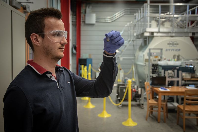 A researcher standing in a research facility.