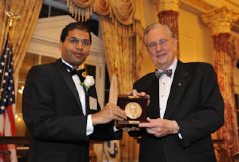 Subhash A. Khot with Arden L. Bement, Jr., NSF Director holding a plaque award