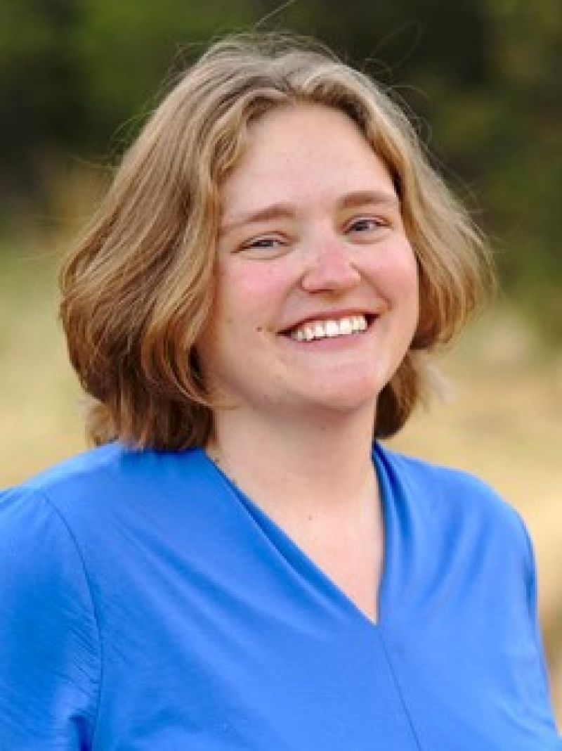 woman with short blonde hair and blue shirt