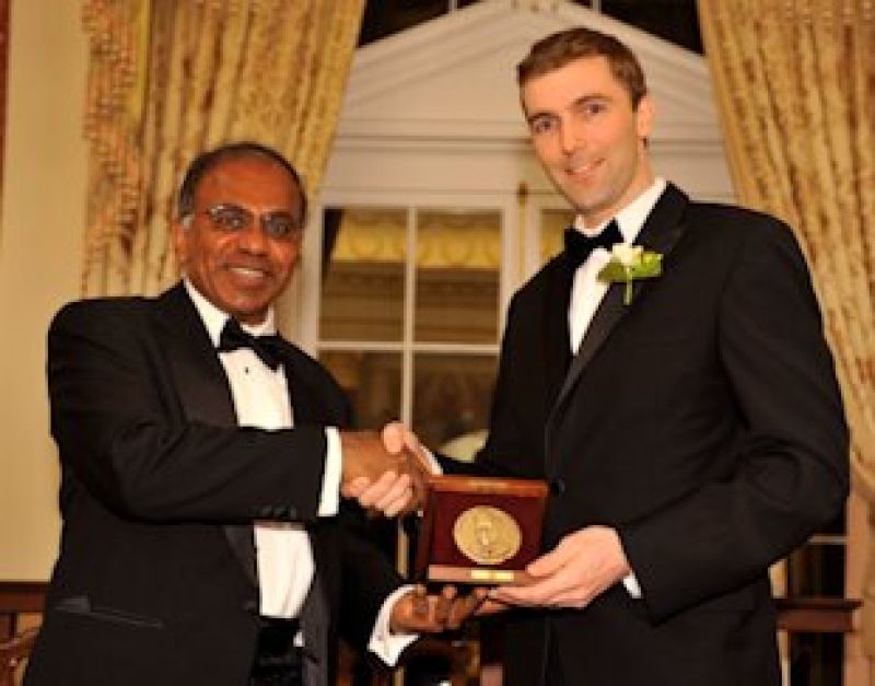 Robert J. Wood with Subra Suresh, NSF Director shaking hands and holding an award