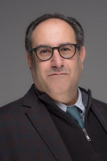 Image of Dr. Darren Ranco wearing a suit with glasses