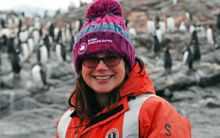 portrait of Rebecca Gast with penguins in the background