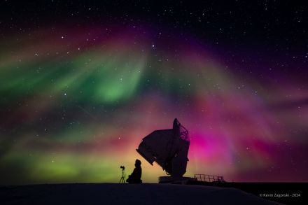 NSF South Pole Station winterover Joshua Veitch-Michaelis takes a photo of auroras with South Pole Telescope in the background