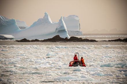 Scientists Ross Nichols (left) and Helena Dodge (right) leave station for a long day of searching for humpback whales to collect samples.