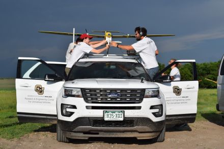 A severe thunderstorm looms overhead as researchers with the Targeted Observation by Radars and UAS of Supercells study load instrumentation onto a "tracker" vehicle prior to launching a drone.
