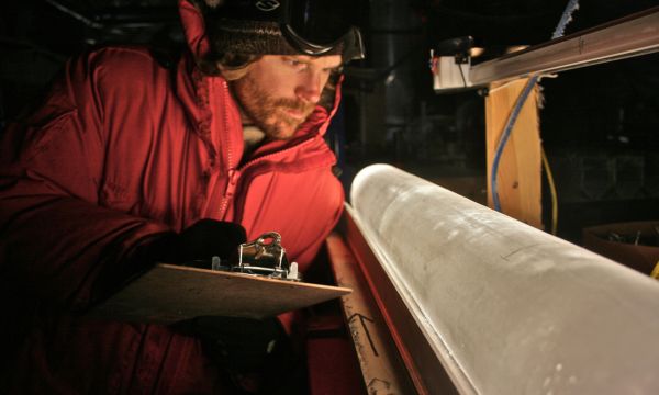 A researcher examines an ice core.