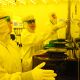 Technicians in clean room learn how to operate the equipment used to make semiconductors