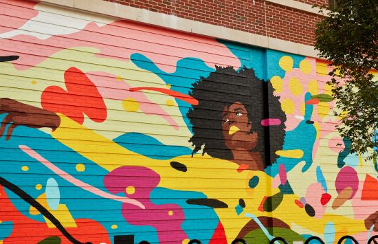 A mural of a woman surrounded by colorful shapes