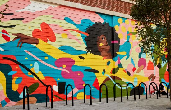 A mural of a woman surrounded by colorful shapes