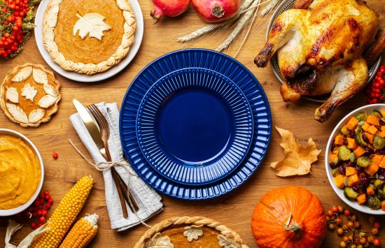 a photo of a plate surrounded by a turkey, pie, a fork