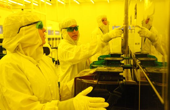 Technicians in clean room learn how to operate the equipment used to make semiconductors