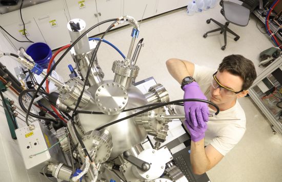 A student adjusts a piece of laboratory equipment