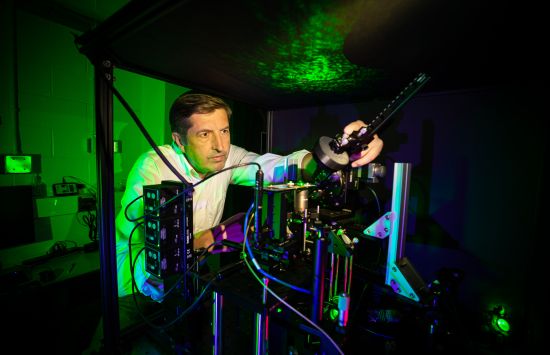 A researcher works on a piece of laboratory equipment