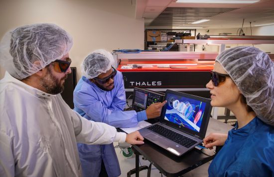 researchers in lab in front of computer