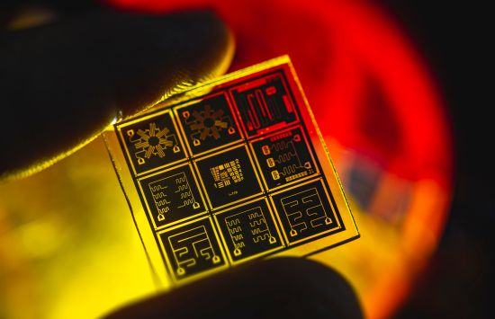 a yellow and orange close-up view of a quantum chip