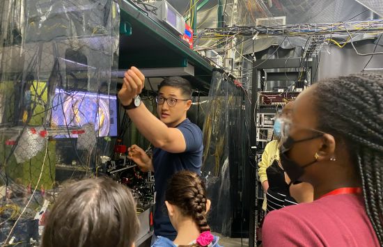 High school students in the University of Maryland's Advanced Physics Summer Girls' Camp view an ion trap