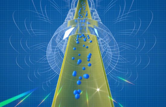 Small blue spheres representing antihydrogen atoms fall downward through a cylindrical apparatus.