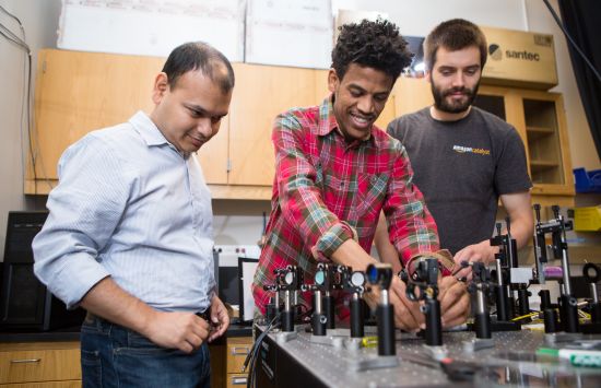 A student working with his mentor and supervisor in the lab