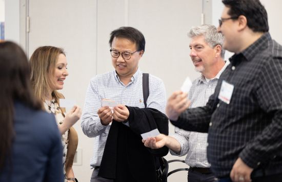 A group of people talking at a conference