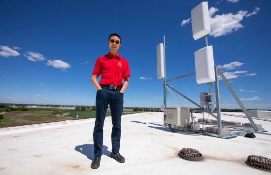 A man stands next to equipment that's part of an advanced wireless networking system