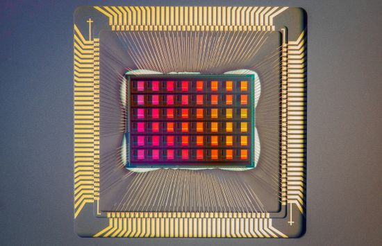 A closeup of a computer chip, featuring a red grid surrounded by golden bands