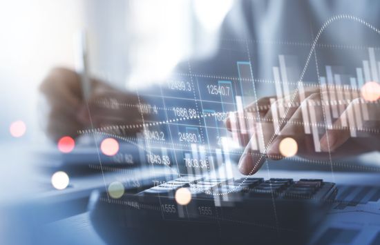 Hands typing on a keyboard overlaid by an abstract illustration of numbers and graphs.