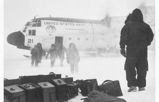 Rear Admiral David M. Tyree, Commander of Operation Deep Freeze and other Navy men step from the LC-130 aircraft. This plane was the first to fly into Amundsen-Scott Station for the summer support season of Deep Freeze in 1962.