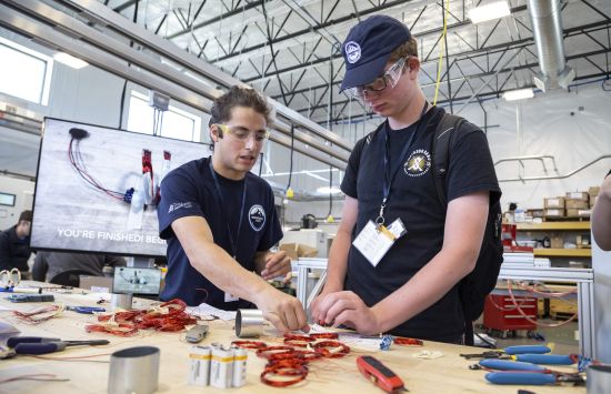 Two students at a work bench.
